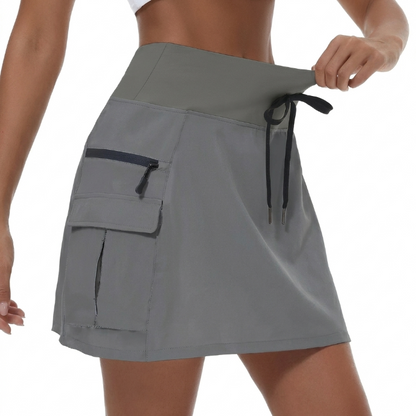 Falda corta mujer deportiva talle alto con bolsillos cremallera